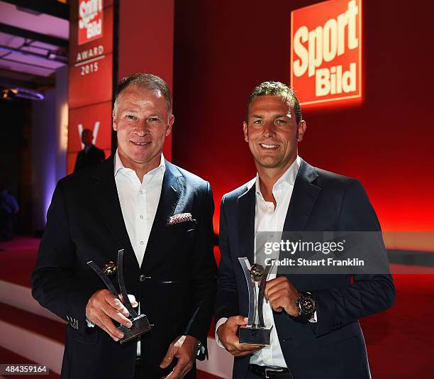 Markus Weinzierl and Stefan Reuter of Augsburg hold their awards at the Sport Bild Awards 2015 on August 17, 2015 in Hamburg, Germany.