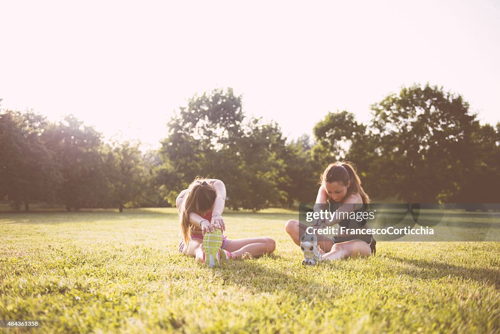 Two woman stretching at the park