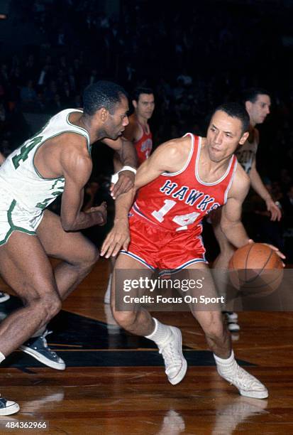 Lenny Wilkens of the St. Louis Hawks drives on Sam Jones of the Boston Celtics during an NBA basketball game circa 1965 at the Boston Garden in...