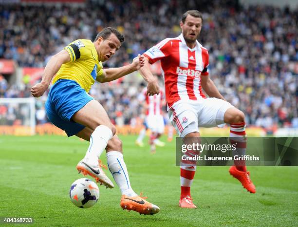 Steven Taylor of Newcastle United battles with Eric Pieters of Stoke City during the Barclays Premier League match between Stoke City and Newcastle...