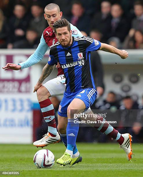 Burnley's David Jones competes with Middlesbrough's Jacob Butterfield during the Sky Bet Championship match between Burnley and Middlesbrough at Turf...