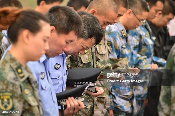 Representatives of People's Liberation Army and public security mourn the dead in Tianjin warehouse explosion on the first seventh day on August 18,...