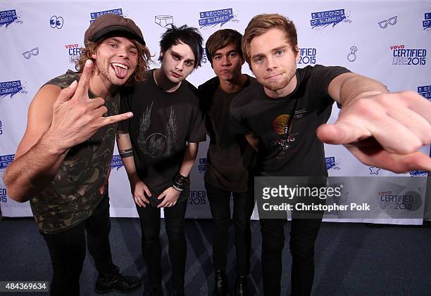 Musicians Ashton Irwin, Michael Clifford, Calum Hood and Luke Hemmings of 5 Seconds of Summer pose backstage during Vevo Certified Live at Barker...