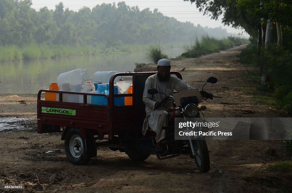 Pakistani water suppliers are collecting water from the...