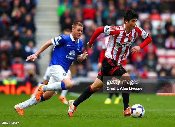 Ki Sung-Yong of Sunderland is marshalled by James McCarthy of Everton during the Barclays Premier League match between Sunderland and Everton at...