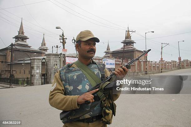 Paramilatary soldier stands guard during restrictions in old city of Srinagar, as Mirwaiz Umer Farooq, chairman of the separatist moderate Hurriyat...