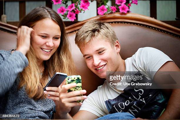 Germany Young couple sitting on a couch staying outside in the garden on August 10, 2015 in Bonn, Germany.