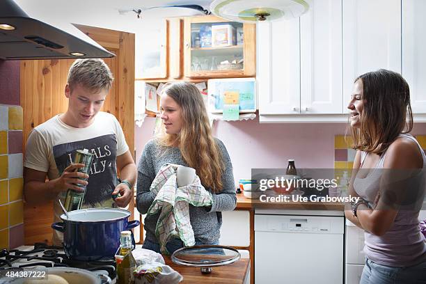 Germany Three youth sitting on a couch staying outside in the garden on August 10, 2015 in Bonn, Germany.