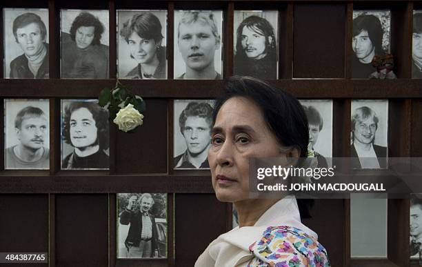 Myanmar pro-democracy icon Aung San Suu Kyi turns around after placing a flower on a memorial for victims of the Berlin wall during a visit to the...