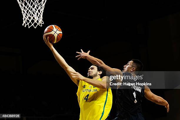 Chris Goulding of the Boomers lays up under pressure from Reuben Te Rangi of the Tall Blacks during the game two match between the New Zealand Tall...