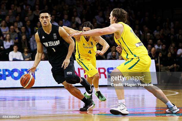 Reuben Te Rangi of the Tall Blacks looks to beat the defence of Cameron Bairstow of the Boomers during the game two match between the New Zealand...