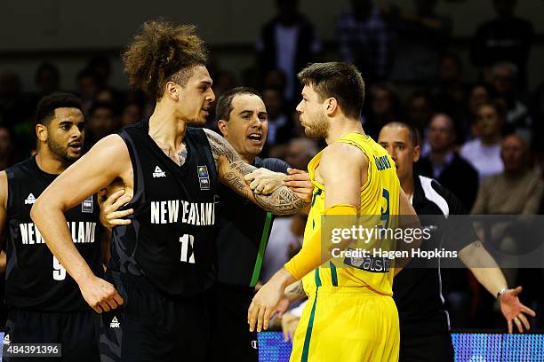 Isaac Fotu of the Tall Blacks exchanges words with Matthew Dellavedova of the Boomers during the game two match between the New Zealand Tall Blacks...