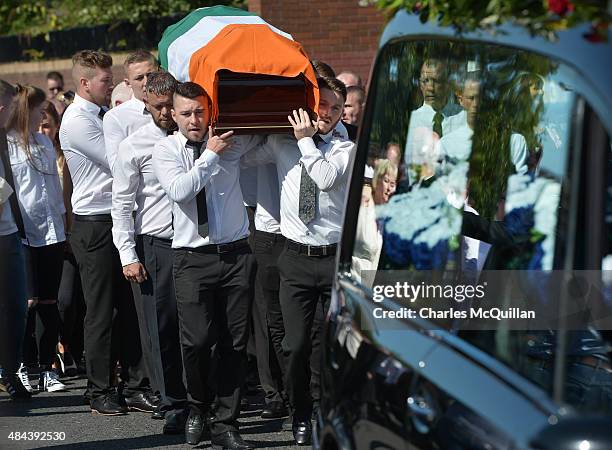 The casket is carried in as the funeral takes place of former IRA member Kevin McGuigan Sr on August 18, 2015 in Belfast, Northern Ireland. The...