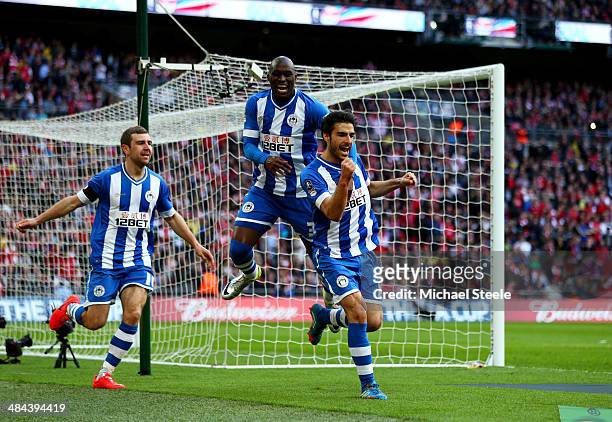 Jordi Gomez of Wigan Athletic celebrates scoring from the penalty spot with Marc-Antoine Fortune and James McArthur of Wigan Athletic during the FA...