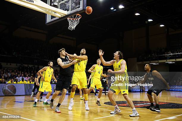 Robert Loe of the Tall Blacks, Andrew Bogut and Cameron Bairstow of the Boomers compete for the ball during the game two match between the New...