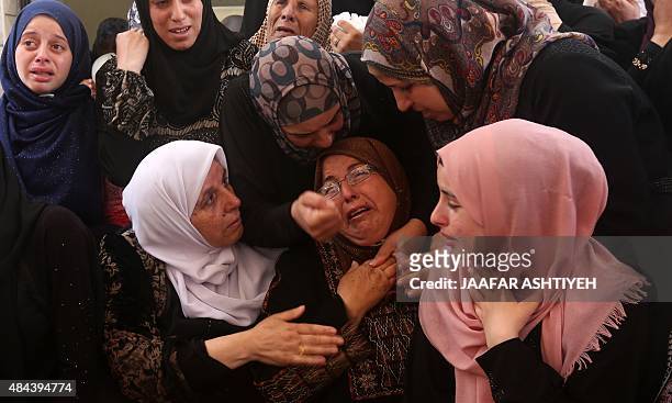 Relatives and friends mourn during the funeral of Mohammed Bassam Amsha al-Atrash, a Palestinian who was shot dead by Israeli troops the day before...