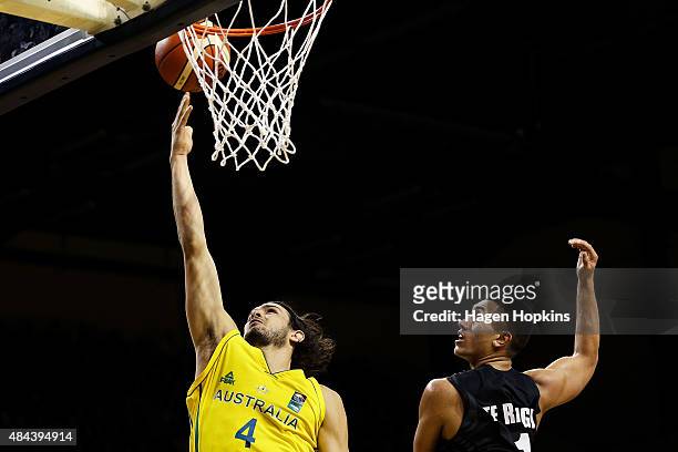 Chris Goulding of the Boomers lays up under pressure from Reuben Te Rangi of the Tall Blacks during the game two match between the New Zealand Tall...