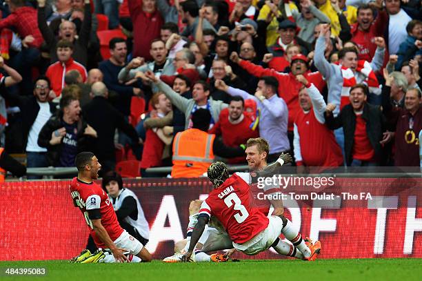 Per Mertesacker of Arsenal celebrates with team-mates Bacary Sagna and Alex Oxlade-Chamberlain after scoring a goal during the FA Cup Semi-Final...