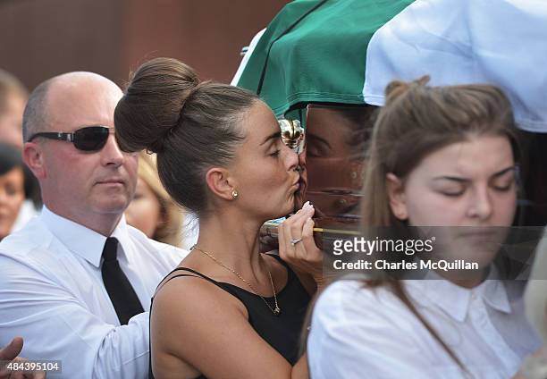 Young woman kisses the coffin of Kevin McGuigan Sr as the funeral takes place of the former IRA member on August 18, 2015 in Belfast, Northern...