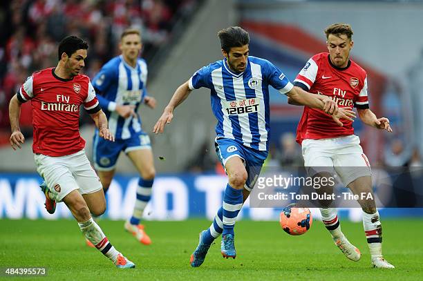 Jordi Gomez of Wigan Athletic in action with Aaron Ramsey of Arsenal during the FA Cup Semi-Final match between Wigan Athletic and Arsenal at Wembley...