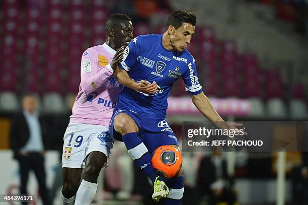 Evian's French defender Yousouf Sabali vies with Bastia's Belgian forward Gianni Bruno during the French L1 football match between Evian Thonon...