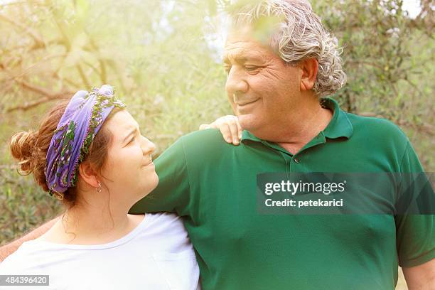 father and daughter hugging in nature - 21st century stock pictures, royalty-free photos & images