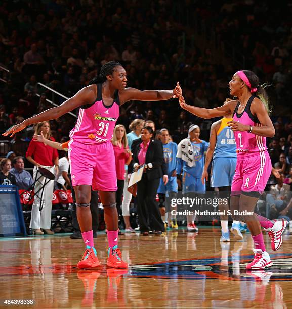 Tina Charles and Candice Wiggins of the New York Liberty shake hands during the game against the Chicago Sky on August 11, 2015 at Madison Square...