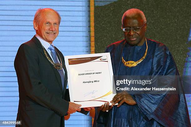 President Lamine Diack hands over the Silver Order of Merit to Hansjoerg Wirz during the IAAF Congress Opening Ceremony at the Great Hall of the...