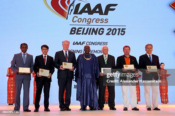 President Lamine Diack hands over pose with the Plaque of Merit award winner Vivian Gungaram, Tigor Mangapul Tanjung, Karel Pilny, Keith Parker and...