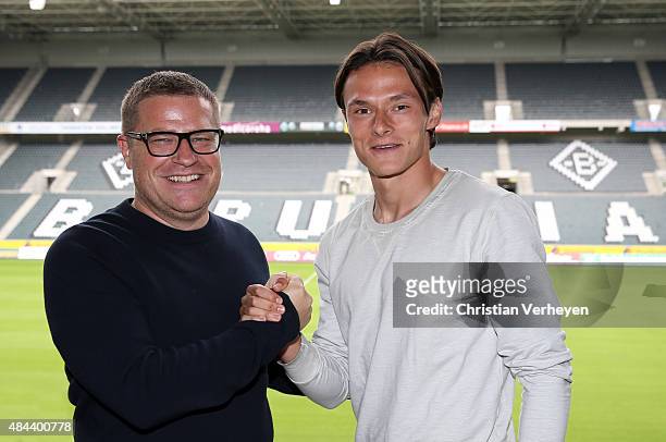 Director of Sport Max Eberl of Borussia Moenchengladbach and Nico Schulz after he signs a new contract for Borussia Moenchengladbach on Augsut 18,...