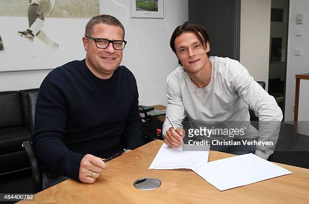 Director of Sport Max Eberl of Borussia Moenchengladbach and Nico Schulz after he signs a new contract for Borussia Moenchengladbach on Augsut 18,...