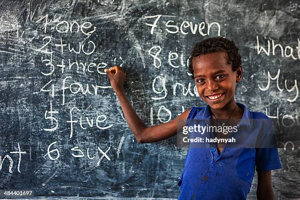 african little boy is learning english language - seven point stock pictures, royalty-free photos & images