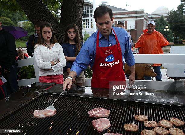 Republican presidential candidate and U.S. Sen. Marco Rubio mans the grill with at the Iowa Pork Producers Pork Tent during the Iowa State Fair on...