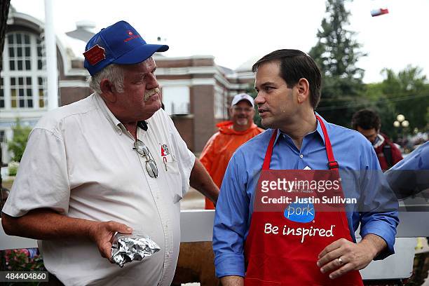Republican presidential candidate and U.S. Sen. Marco Rubio talks with Duane Dreager at the Iowa Pork Producers Pork Tent during the Iowa State Fair...