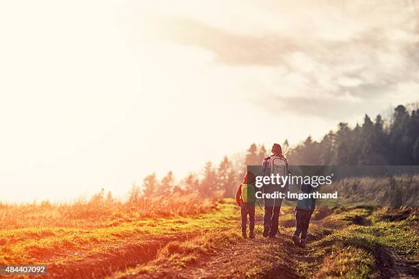 mother and little kids hiking in moutains - fall hiking stock pictures, royalty-free photos & images