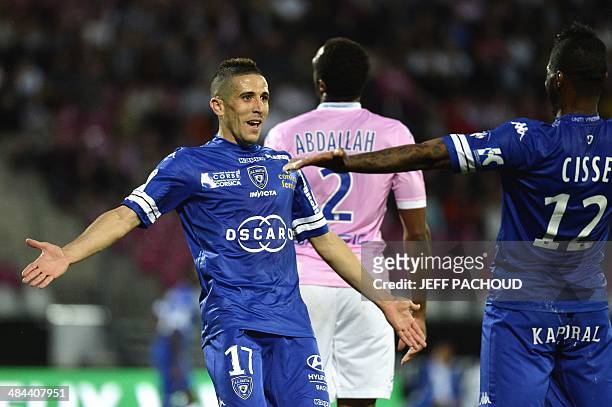 Bastia's French midfielder Florian Raspentino celebrates with his teamate French forward Djibril Cisse after scoring a goal during the French L1...