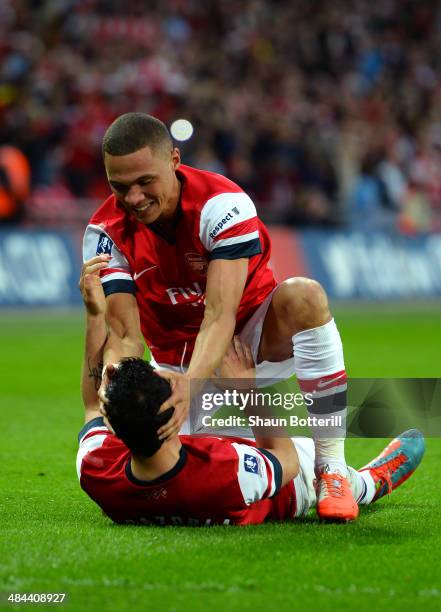 Kieran Gibbs of Arsenal congratulates Santi Cazorla of Arsenal on scoring the winning penalty during the FA Cup Semi-Final match between Wigan...