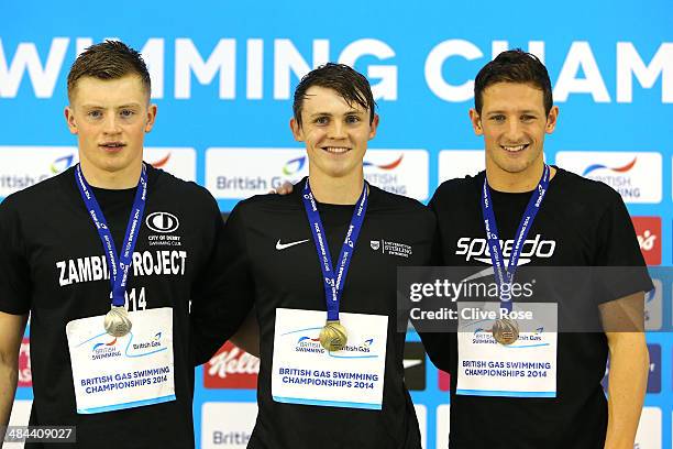 Ross Murdoch poses with his medal on the podium with Michael Jamieson and Adam Peaty after winning the Men's 100m Breaststroke Final on day three of...