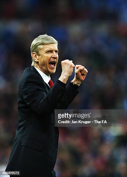 Arsene Wenger, manager of Arsenal celebrates after winning the penalty shoot-out to claim victory in the FA Cup Semi-Final match between Wigan...