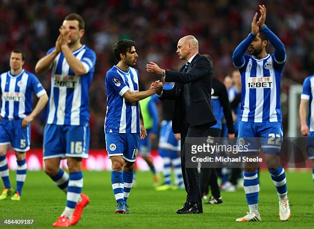 Uwe Rosler, manager of Wigan Athletic consoles Jordi Gomez of Wigan Athletic during the FA Cup Semi-Final match between Wigan Athletic and Arsenal at...