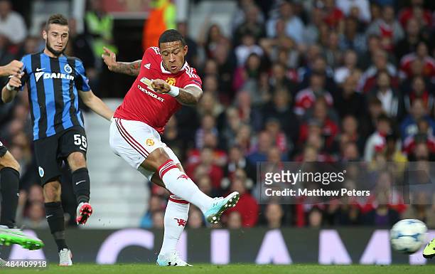 Memphis Depay of Manchester United scores their first goal during the UEFA Champions League play-off first leg match between Manchester United and...
