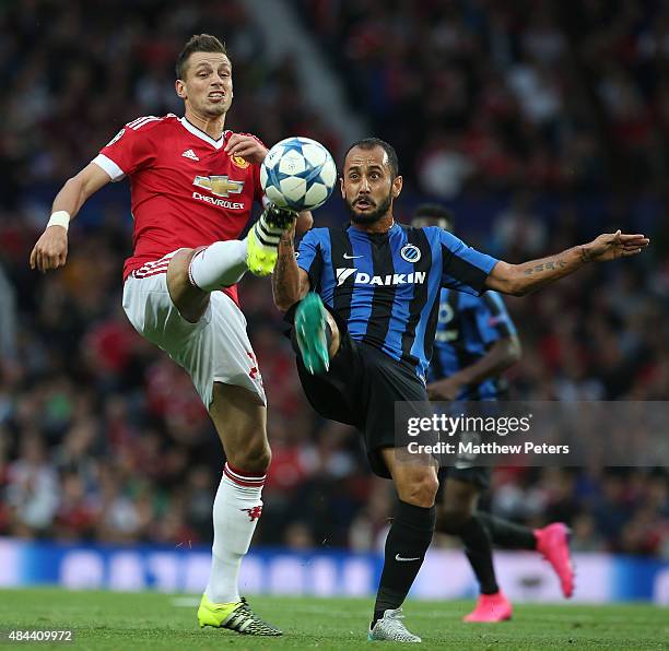 Morgan Schneiderlin of Manchester United in action with Victor Vazquez of Club Brugge during the UEFA Champions League play-off first leg match...