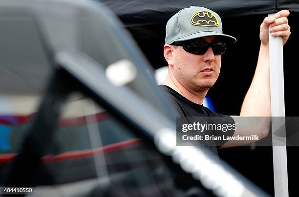 Kyle Busch, driver of the JEGS Toyota, stands in the garage during practice for the NASCAR Camping World Truck Series UNOH 200 race at Bristol Motor...