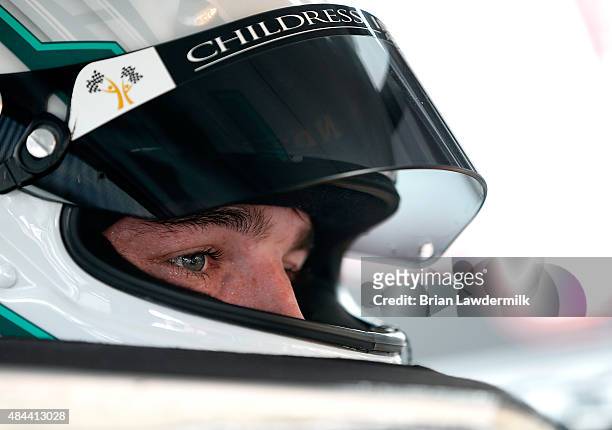 Ty Dillon, driver of the GunBroker.com Chevrolet, sits in his car during practice for the NASCAR Camping World Truck Series UNOH 200 race at Bristol...