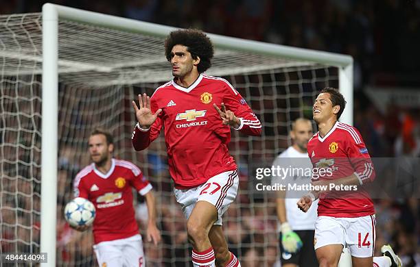 Marouane Fellaini of Manchester United celebrates scoring their third goal during the UEFA Champions League play-off first leg match between...