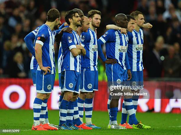 Jordi Gomez of Wigan Athletic and team mates look on during the penalty shoot out during the FA Cup Semi-Final match between Wigan Athletic and...