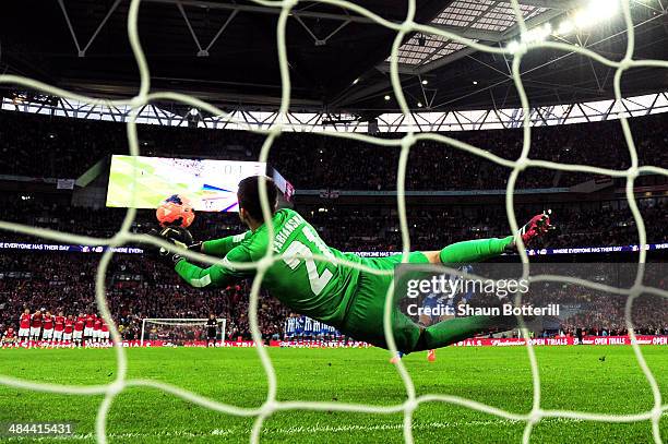 Lukasz Fabianski of Arsenal saves Jack Collison of Wigan Athletic's penalty during the shoot out during the FA Cup Semi-Final match between Wigan...