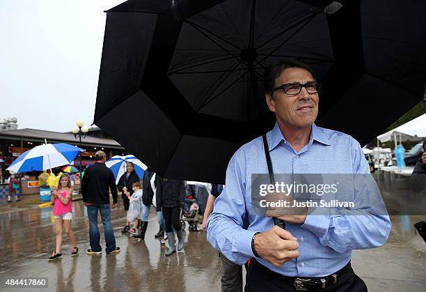 Republican presidential candidate and former Texas Gov. Rick Perry tours the Iowa State Fair on August 18, 2015 in Des Moines, Iowa. Presidential...