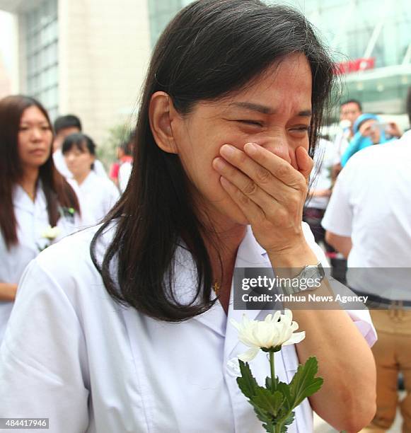 Aug. 18, 2015-- A medical staff member cries while mourning for the victims of the massive warehouse explosions at Taida Hospital near the explosion...