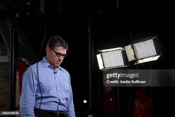 Republican presidential candidate and former Texas Gov. Rick Perry pauses after conducting a television news interview at the Iowa State Fair on...